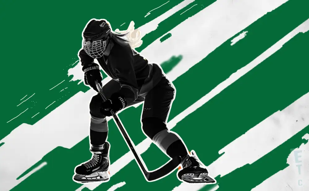 a boston pwhl ice hockey player dribling